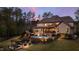 Luxury home with pool and outdoor entertaining areas at dusk at 2117 Blue Haven Ct, Wake Forest, NC 27587