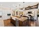 Open kitchen features a large island with a farmhouse sink and views into the living room at 2117 Blue Haven Ct, Wake Forest, NC 27587