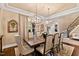 Formal dining room with a large table, chandelier, and hardwood floors at 2117 Blue Haven Ct, Wake Forest, NC 27587