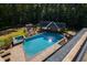 Large inground pool with spa and outdoor entertainment area at 2117 Blue Haven Ct, Wake Forest, NC 27587