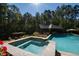 Luxury pool and spa with stonework, surrounded by lush landscaping at 2117 Blue Haven Ct, Wake Forest, NC 27587