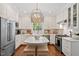 Modern kitchen with white cabinets, stainless steel appliances, and marble island at 3001 Randolph Dr, Raleigh, NC 27609