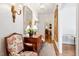 Elegant entryway featuring hardwood floors, antique chair and mirror at 3001 Randolph Dr, Raleigh, NC 27609