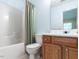 Clean bathroom with shower/tub combo and wood vanity at 1721 Sorrell Brook Way, Raleigh, NC 27609