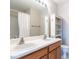 Double vanity bathroom with a shower and linen storage at 1721 Sorrell Brook Way, Raleigh, NC 27609