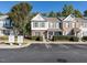 Townhome exterior view showcasing landscaping and parking area at 1721 Sorrell Brook Way, Raleigh, NC 27609