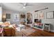Bright living room with hardwood floors, comfy couch, and built-in shelving at 113 Higbee St, Durham, NC 27704
