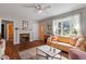 Bright living room with hardwood floors, fireplace, and large window at 113 Higbee St, Durham, NC 27704