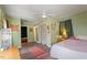 Large bedroom with a ceiling fan and access to a spacious closet at 113 Higbee St, Durham, NC 27704
