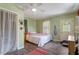Charming bedroom with a ceiling fan, neutral walls, and a door leading outside at 113 Higbee St, Durham, NC 27704