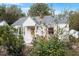 Front view of a charming white brick house with a well-maintained yard at 113 Higbee St, Durham, NC 27704