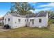 Rear view of the home showing a patio, shed, and brick exterior at 113 Higbee St, Durham, NC 27704
