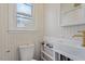 Updated bathroom with a pedestal sink, toilet and herringbone patterned walls at 113 Higbee St, Durham, NC 27704