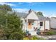 Charming white brick home with a yellow door and landscaped yard at 113 Higbee St, Durham, NC 27704
