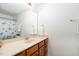 Bathroom with single sink vanity, shower/tub combo and wood cabinets at 542 Redford Place Dr, Rolesville, NC 27571