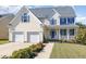 Two-story house featuring a two car garage and manicured lawn at 542 Redford Place Dr, Rolesville, NC 27571