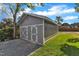 Gray detached garage with double doors and gravel driveway at 505 S Magnolia Ave, Dunn, NC 28334