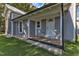 Gray house exterior with a wooden porch and white front door at 505 S Magnolia Ave, Dunn, NC 28334