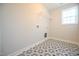 Laundry room with patterned tile floor and shelving at 49 Abingdon Farms Dr, Selma, NC 27576