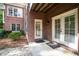 Brick patio with double doors leading to the backyard, offering convenient outdoor access at 303 Devonhall Ln, Cary, NC 27518