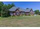 Brick home with a large lawn and mature trees at 512 W Franklin St, Zebulon, NC 27597
