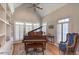 Bright music room with grand piano and built-in shelves at 512 W Franklin St, Zebulon, NC 27597