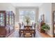 Bright dining room with large windows and hardwood floors at 512 W Franklin St, Zebulon, NC 27597