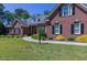 Brick home with a large lawn and mature trees at 512 W Franklin St, Zebulon, NC 27597