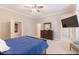 Main bedroom with king-size bed and large TV at 512 W Franklin St, Zebulon, NC 27597