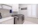 Laundry room with washer, dryer, and ample storage at 512 W Franklin St, Zebulon, NC 27597