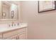 Elegant powder room with white vanity and a large mirror at 512 W Franklin St, Zebulon, NC 27597