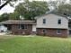 Brick and vinyl-sided two-story house with a landscaped yard and attached carport at 3704 Huntleigh Dr, Raleigh, NC 27604