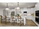Modern kitchen with white cabinets, large island, and stainless steel appliances at 3158 Alden Way, Angier, NC 27501
