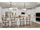 Modern kitchen with white cabinets, large island, and stainless steel appliances at 3158 Alden Way, Angier, NC 27501