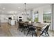 Bright dining room with farmhouse table and chairs, adjacent to kitchen at 3158 Alden Way, Angier, NC 27501