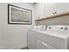 Bright laundry room with washer, dryer, and overhead cabinets at 3158 Alden Way, Angier, NC 27501