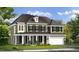 Two-story house with green siding, white columns, and a three-car garage at 3158 Alden Way, Angier, NC 27501