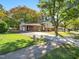 Brick ranch house with carport and mature trees at 3704 Huntleigh Dr, Raleigh, NC 27604