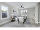 Light-filled living room with gray sofa and wood floors at 3010 Garner Rd # 101, Raleigh, NC 27610