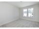 Bright bedroom with carpet flooring and two large windows at 3010 Garner Rd # 101, Raleigh, NC 27610