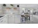 Modern kitchen with white cabinets, quartz countertops, and an island with seating at 3010 Garner Rd # 101, Raleigh, NC 27610
