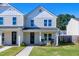 Two-story white house with front porch and rocking chairs at 3010 Garner Rd # 101, Raleigh, NC 27610