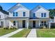 Two-story white house with front porch, landscaping, and walkway at 3010 Garner Rd # 101, Raleigh, NC 27610