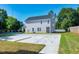 Side view of a two story house with a large concrete parking area and grassy yard at 3010 Garner Rd # 101, Raleigh, NC 27610