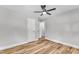 Bright bedroom with wood-look floors, ceiling fan, and double closets at 3440 Apache Dr, Raleigh, NC 27609