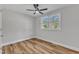 Bedroom with wood-look floors, ceiling fan, and window with blinds at 3440 Apache Dr, Raleigh, NC 27609