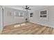 Well-lit bedroom with hardwood floors, ceiling fan and two windows at 3440 Apache Dr, Raleigh, NC 27609