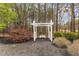 White pergola with a bench, surrounded by lush landscaping at 2000 Silverleaf Dr, Youngsville, NC 27596