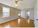 Hardwood floor bedroom with ceiling fan and private bathroom access at 414 Ward St, Graham, NC 27253