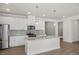 Modern kitchen with white cabinets, granite island, and stainless steel appliances at 202 Bering Cir, Angier, NC 27501